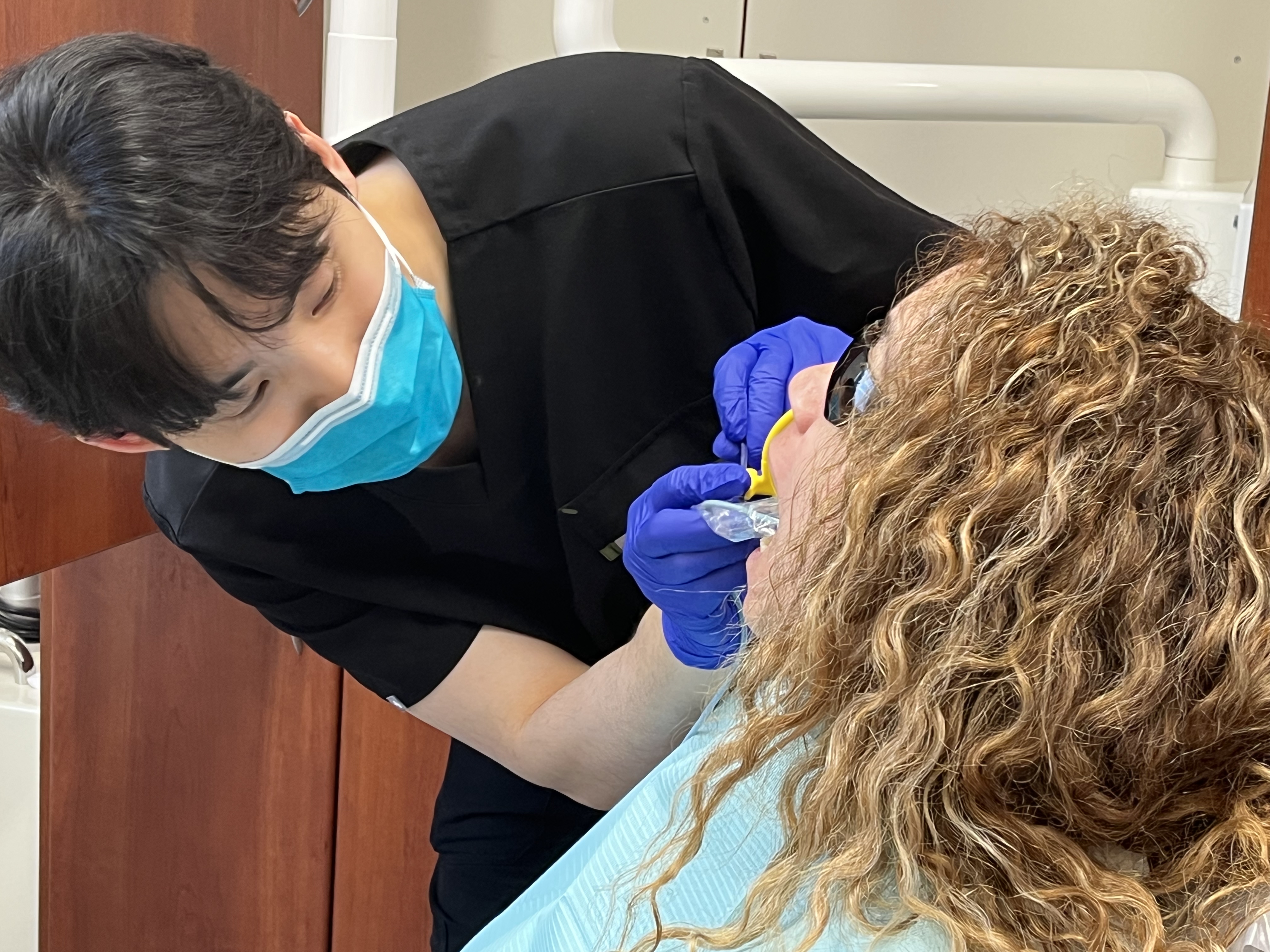 Dentist helping patient